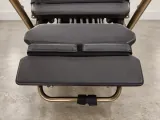 Carriage One front platform padding, split strap, spring row, and bronze end rail viewed from above