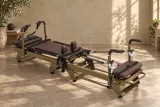 Bronze Carriage One family reformer with brown upholstery in a warm studio