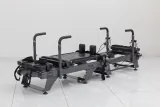 Carriage One S compact reformer with grey upholstery viewed from the opposite end