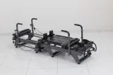 Carriage One S compact reformer with grey upholstery, platforms and raised handles
