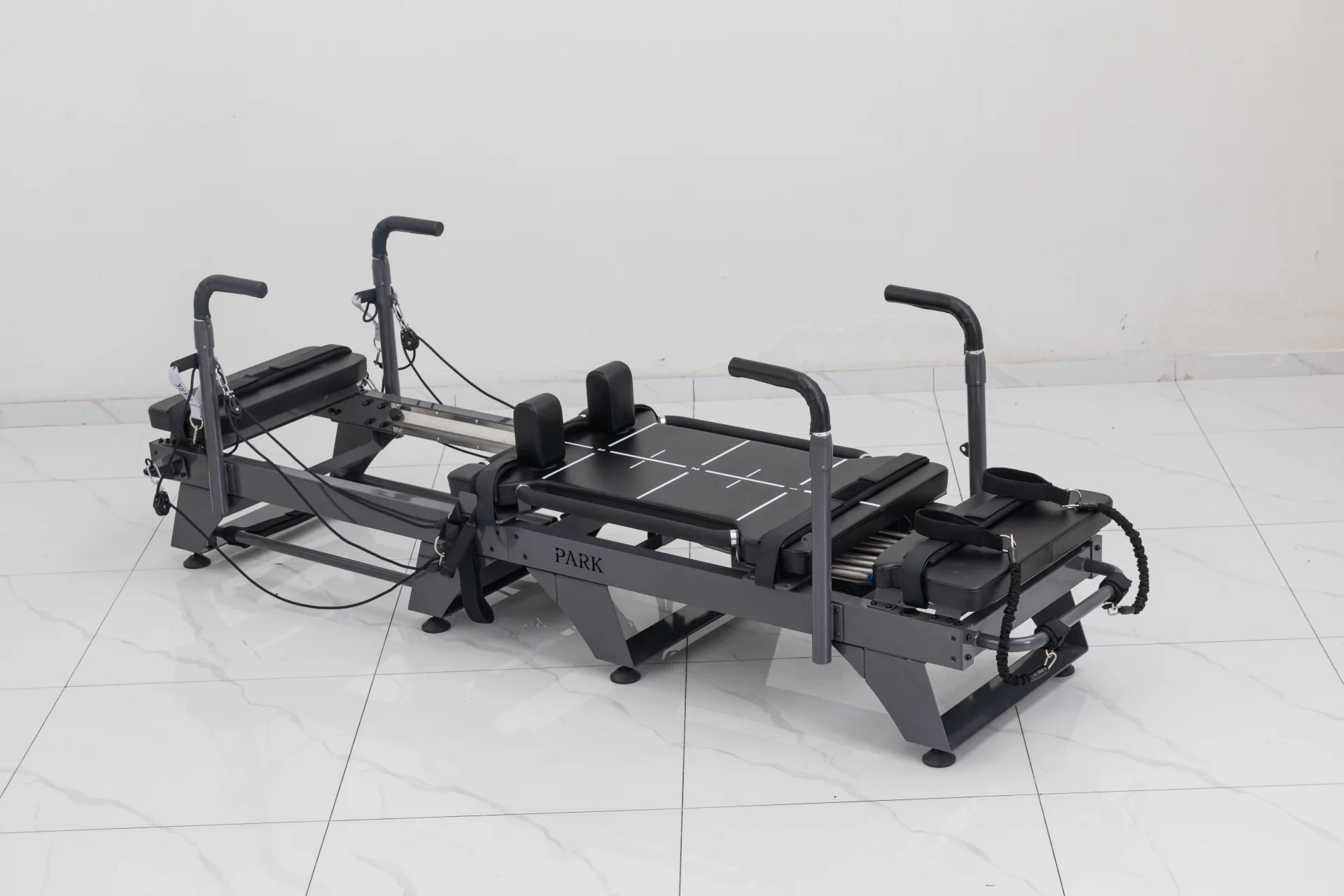 Carriage One S compact reformer with grey upholstery, platforms and raised handles