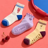 Lobster, bow, and martini custom grip sock design directions arranged with studio props