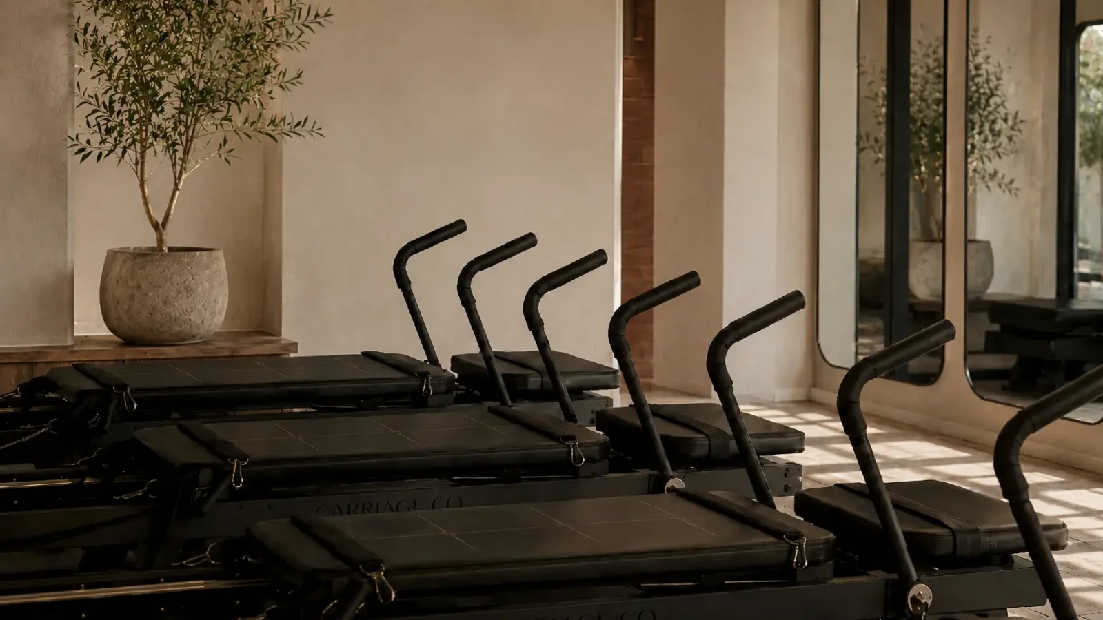 Exact Carriage One machines repeated across a warm studio room